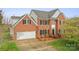 Charming two-story brick home with black shutters, attached two-car garage, and professionally landscaped yard at 1919 46Th Avenue Ne Dr # 46, Hickory, NC 28601
