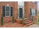 Classic brick home with a welcoming front entrance, complemented by meticulously maintained landscaping and stylish exterior lighting at 1919 46Th Avenue Ne Dr # 46, Hickory, NC 28601