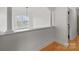 Bright hallway with hardwood floors and a large window looking out over the front yard at 1919 46Th Avenue Ne Dr # 46, Hickory, NC 28601