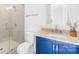 Modern bathroom features a blue vanity, glass shower, and neutral tile at 2010 Bessbrook Rd, Fort Mill, SC 29708
