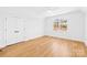 Bedroom features hardwood floors, double doors, and a bright window at 2010 Bessbrook Rd, Fort Mill, SC 29708