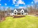 Striking white farmhouse with black trim, beautiful lawn, and manicured landscaping at 2010 Bessbrook Rd, Fort Mill, SC 29708