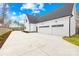 A spacious three-car garage with modern doors and ample parking space at 2010 Bessbrook Rd, Fort Mill, SC 29708