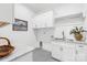 Clean laundry room with granite countertop, white cabinets, and stainless steel sink at 2010 Bessbrook Rd, Fort Mill, SC 29708