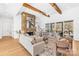 Inviting living room with a stone fireplace, wood beams, and abundant natural light at 2010 Bessbrook Rd, Fort Mill, SC 29708