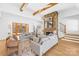 Bright living room with stone fireplace, exposed wood beams, hardwood floors, and french doors to the outside at 2010 Bessbrook Rd, Fort Mill, SC 29708