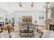 Spacious living room with stone fireplace, exposed wood beams, hardwood floors, and connected dining room at 2010 Bessbrook Rd, Fort Mill, SC 29708