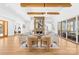 Bright living room with stone fireplace, exposed wood beams, hardwood floors, and sliding glass doors to the outside at 2010 Bessbrook Rd, Fort Mill, SC 29708