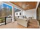 Covered patio with wood flooring, ceiling fan, and outdoor seating area overlooking backyard at 2010 Bessbrook Rd, Fort Mill, SC 29708