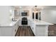 Modern kitchen features white cabinets, stainless steel appliances, and breakfast bar at 209 Palmer St, Shelby, NC 28150