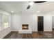 Cozy living room features fireplace, large window, and hardwood floors at 209 Palmer St, Shelby, NC 28150
