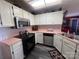 Functional kitchen featuring a black stove, stainless steel microwave, and ample counter space at 2234 Oak Leigh Dr, Charlotte, NC 28262