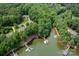 Picturesque aerial view of waterfront homes with docks and boat slips surrounded by lush green trees at 228 Wildwood Cove Dr, Mooresville, NC 28117