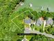 An aerial view of a lakeside home with a well-defined property line in a lush, green, wooded community at 228 Wildwood Cove Dr, Mooresville, NC 28117