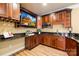 A basement bar featuring wood cabinetry, granite countertops, beverage cooler and a TV at 228 Wildwood Cove Dr, Mooresville, NC 28117