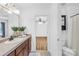 Bright bathroom featuring a single sink with dark wood cabinets at 228 Wildwood Cove Dr, Mooresville, NC 28117