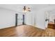 Bedroom with wood floors, a ceiling fan, window, closet, and doorway to a hallway at 228 Wildwood Cove Dr, Mooresville, NC 28117