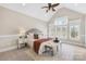 Inviting bedroom featuring plush bedding, vaulted ceiling, and natural light at 228 Wildwood Cove Dr, Mooresville, NC 28117