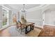 Elegant dining room with natural light, wood floors, and an open archway at 228 Wildwood Cove Dr, Mooresville, NC 28117