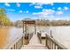 Waterfront property with a private dock featuring a covered boat slip and scenic views at 228 Wildwood Cove Dr, Mooresville, NC 28117