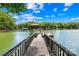 The dock featuring a wooden walkway that leads to the lake and a covered boat slip at 228 Wildwood Cove Dr, Mooresville, NC 28117