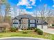 Beautiful exterior view of a two-story home with a three-car garage and manicured landscaping at 228 Wildwood Cove Dr, Mooresville, NC 28117