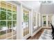 Bright hallway with hardwood floors and lots of natural light from multiple windows and doors at 228 Wildwood Cove Dr, Mooresville, NC 28117