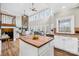 Open concept kitchen features an island, white cabinetry, tile backsplash, and stainless steel appliances at 228 Wildwood Cove Dr, Mooresville, NC 28117