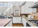 Granite countertops accent this kitchen featuring a gas cooktop, white cabinets, and stainless steel appliances at 228 Wildwood Cove Dr, Mooresville, NC 28117