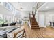 Bright, open-concept living room with a staircase and large windows at 228 Wildwood Cove Dr, Mooresville, NC 28117