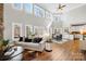 Bright, open-concept living room with a view of the dining area and stone fireplace at 228 Wildwood Cove Dr, Mooresville, NC 28117
