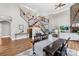 Living room area featuring a dining table, a staircase, and modern decor at 228 Wildwood Cove Dr, Mooresville, NC 28117