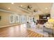 Large living room with wood floors, recessed lighting, fan, and access to a bar area at 228 Wildwood Cove Dr, Mooresville, NC 28117