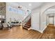 Spacious living room boasts soaring windows, a stone fireplace, and hardwood floors for a modern aesthetic at 228 Wildwood Cove Dr, Mooresville, NC 28117