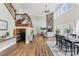 Open-concept living room with a fireplace, staircase, and wine storage at 228 Wildwood Cove Dr, Mooresville, NC 28117