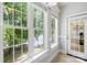 Light-filled sunroom featuring a lake view, a door to the outdoor living area, and plush carpeting at 228 Wildwood Cove Dr, Mooresville, NC 28117