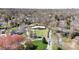 An aerial view of a home on a tree-filled lot with an expansive backyard and circular driveway at 2300 Cloister Dr, Charlotte, NC 28211