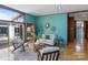 Comfortable living room with blue walls, hardwood floors, mid-century modern furniture, and natural light at 2300 Cloister Dr, Charlotte, NC 28211