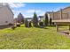 Lush green backyard with manicured landscaping and a view of the deck at 2464 Chatham Dr, Indian Land, SC 29707