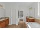 Primary bath featuring granite countertops, double vanities, separate tub and doorway leading to bedroom at 2464 Chatham Dr, Indian Land, SC 29707