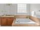 Bright bathroom featuring granite countertops, separate soaking tub, and natural light at 2464 Chatham Dr, Indian Land, SC 29707