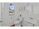 Bathroom featuring hardwood floors, a pedestal sink, toilet, and natural light at 2464 Chatham Dr, Indian Land, SC 29707