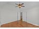 Empty bedroom featuring hardwood floors, a ceiling fan, and a door leading to the hallway at 2464 Chatham Dr, Indian Land, SC 29707