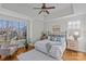 Bedroom with tray ceiling, hard wood floors, large windows, and neutral decor at 2464 Chatham Dr, Indian Land, SC 29707
