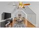 Cozy bonus room featuring vaulted ceilings, modern décor, and a large flat-screen TV at 2464 Chatham Dr, Indian Land, SC 29707
