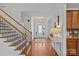 Bright foyer with hardwood floors, decorative table, staircase, and stylish light fixture at 2464 Chatham Dr, Indian Land, SC 29707