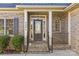 Inviting front entrance with decorative glass door, brick steps, and classic white pillars at 2464 Chatham Dr, Indian Land, SC 29707