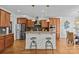 Island kitchen featuring wood cabinets, stainless steel appliances, and pendant lighting at 2464 Chatham Dr, Indian Land, SC 29707