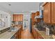 Kitchen featuring stainless steel appliances, wood cabinets, granite counters, and hard wood floors at 2464 Chatham Dr, Indian Land, SC 29707