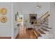 Open-concept living room with hardwood floors, stone fireplace, and large windows offering ample light at 2464 Chatham Dr, Indian Land, SC 29707